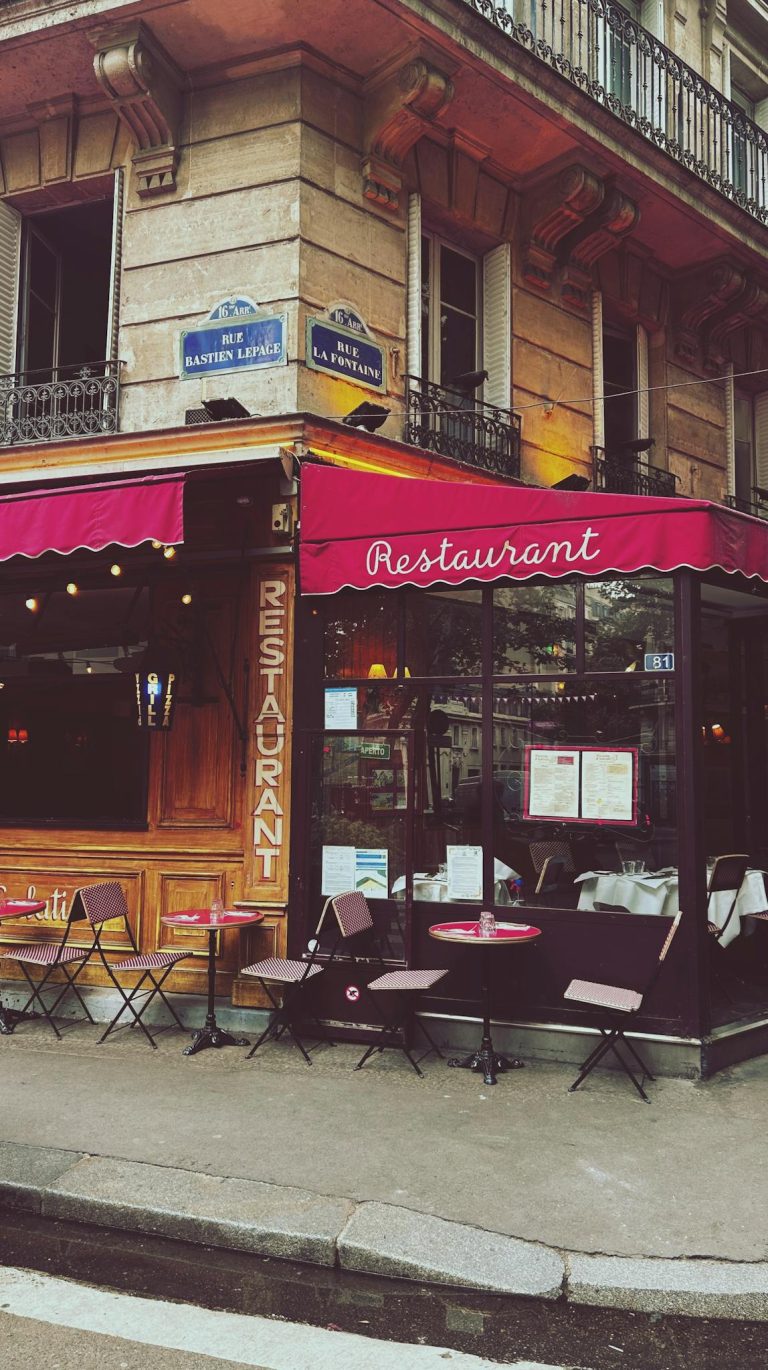 Cozy Parisian restaurant with outdoor seating on a classic street corner, perfect for dining and enjoying city life.