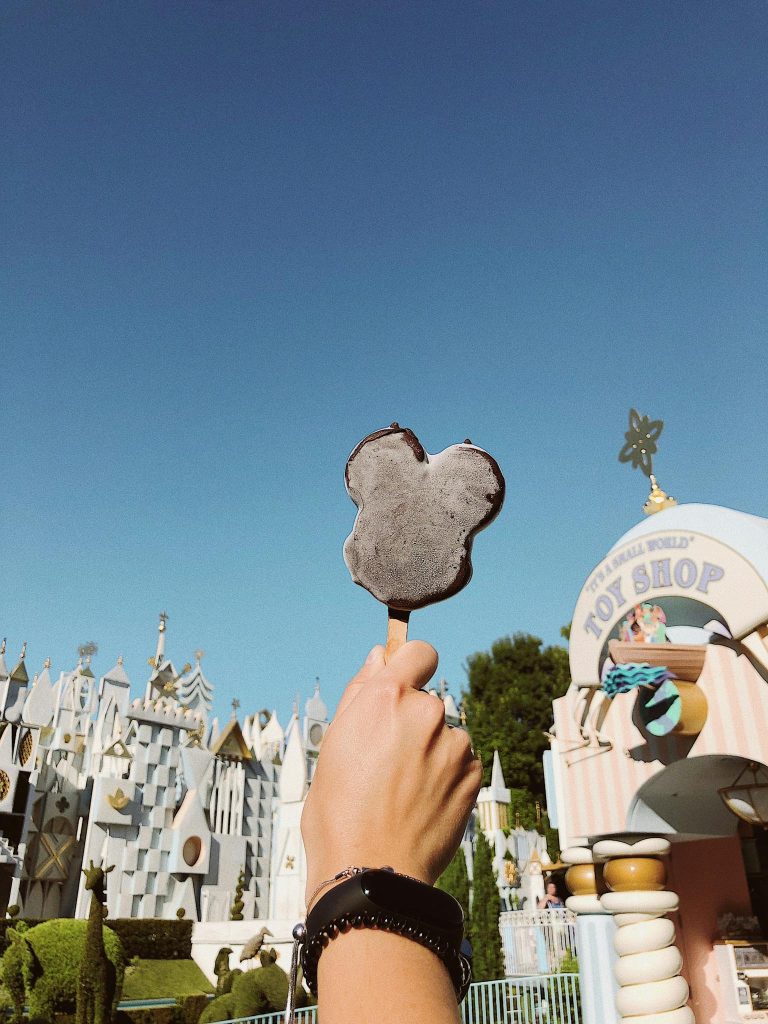Enjoy a sunny day at Disneyland Anaheim with a tasty Mickey ice cream in hand.